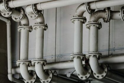 Industrial metal pipes representing manufacturing and building-products supply chains