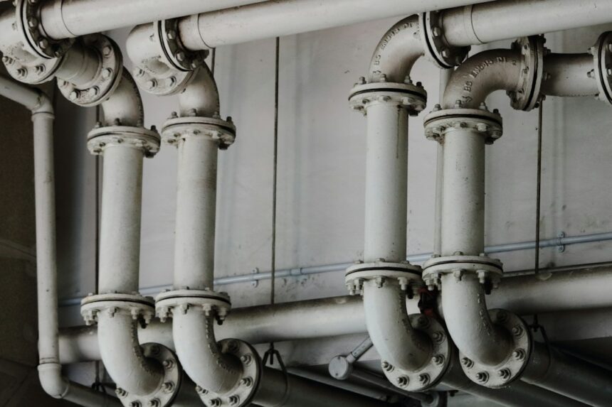 Industrial metal pipes representing manufacturing and building-products supply chains