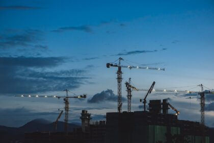 Construction cranes above residential development projects