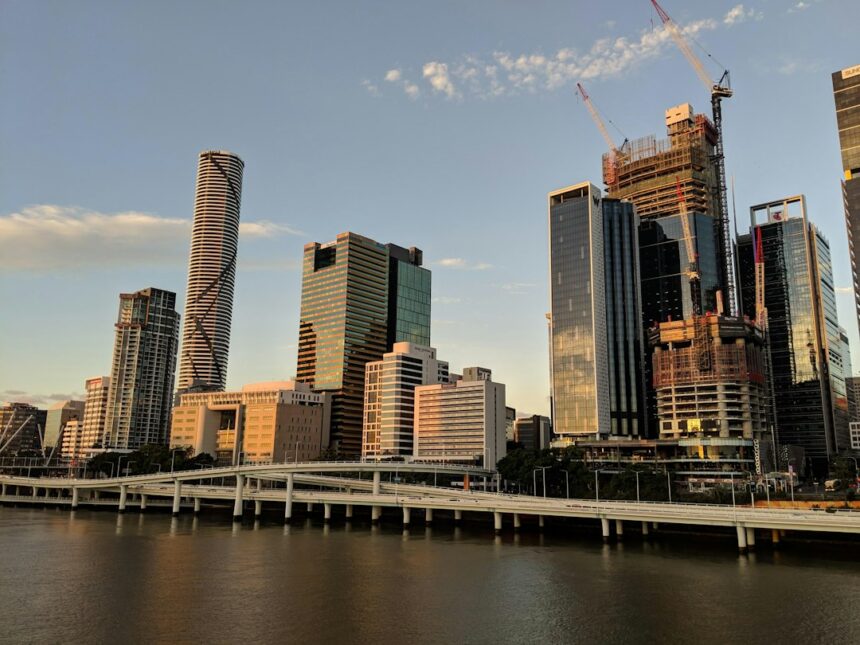 Brisbane city skyline at golden hour; illustrative photograph, not a specific community housing project.