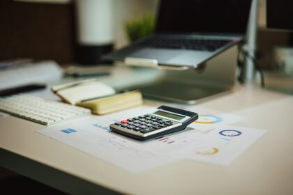 Conceptual financial paperwork and calculator on an office desk
